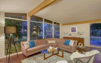 Vaulted ceilings and large, clerestory windows encompass the retro living room space of this 1955 Al Beadle-designed property in Phoenix, AZ. Photo by Hi-Res Media.